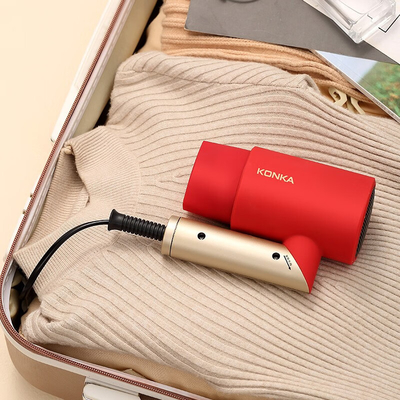 O secador de cabelo dobrável e portátil da agência de viagens com proteção contra vento quente
